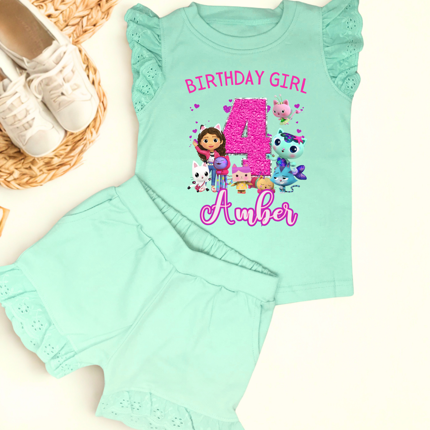 Gabby's dollhouse birthday outfit, An adorable personalised birthday outfit inspired by Gabbie's Dollhouse, featuring a frilly top and matching shorts. The ensemble can be customised with any name and age, making it perfect for a special birthday celebration. Perfect birthday gift for girls, personalised summer outfit