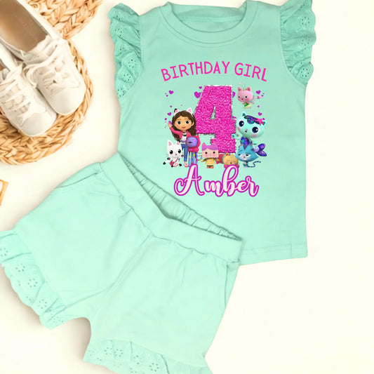 Gabby's dollhouse birthday outfit, An adorable personalised birthday outfit inspired by Gabbie's Dollhouse, featuring a frilly top and matching shorts. The ensemble can be customised with any name and age, making it perfect for a special birthday celebration. Perfect birthday gift for girls, personalised summer outfit