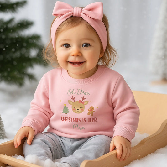 Kids Christmas Sweatshirt for girls with personalised name, cute reindeer, Christmas tree and gingerbread design on a pastel pink festive jumper.
