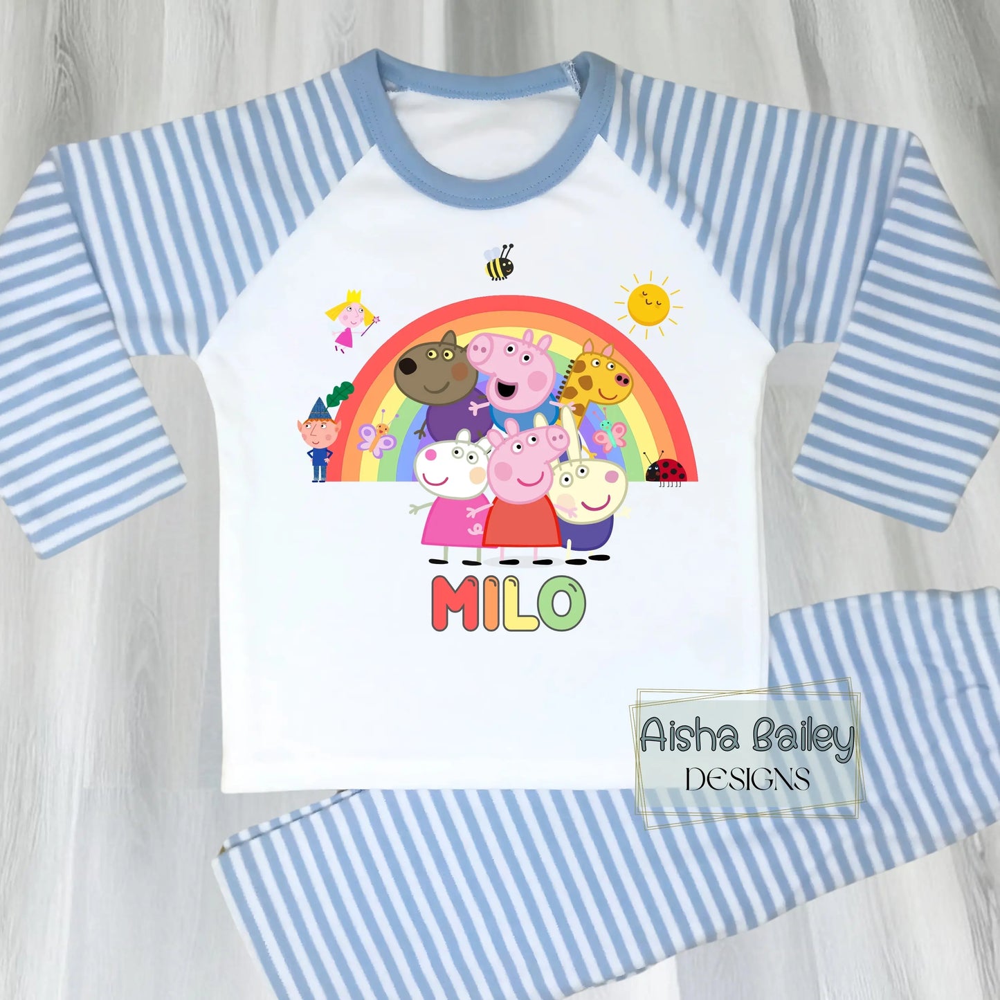 Blue Peppa Pig personalised boys pyjamas set featuring a colourful rainbow design and favourite Peppa Pig characters, customised with name and age. Made from soft, comfortable fabric with a long-sleeve top and matching cloud-print bottoms. Perfect for everyday wear, cosy nights, and relaxed mornings—ideal personalised Peppa Pig sleepwear for toddlers and young children.