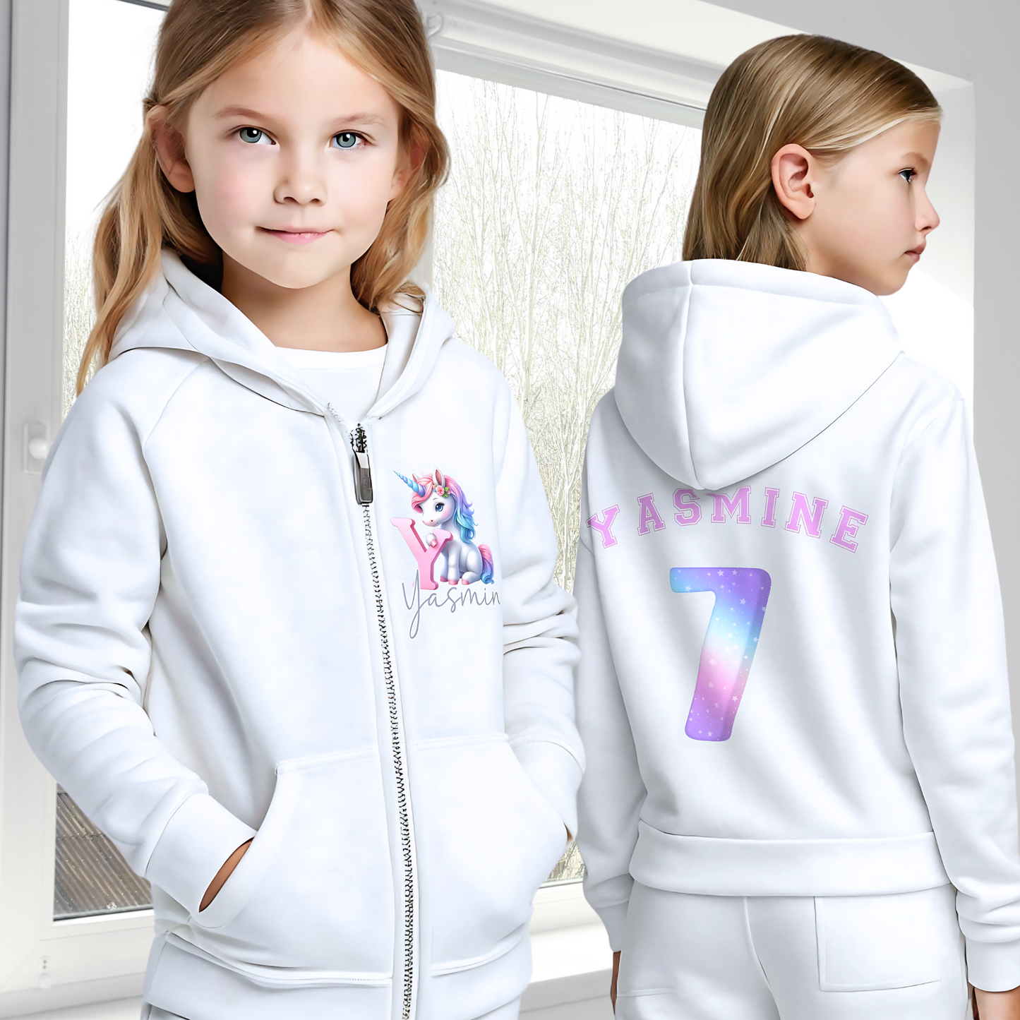 Personalised girls hoodie: A personalised girl's zip-up hoodie featuring a colourful unicorn graphic on the front, along with the girl's initial and name. The back showcases her name and favourite number. Perfect for a unicorn-themed birthday celebration! Custom girls hoodie, unicorn graphic jacket, personalised name and number hoodie, unicorn-themed apparel, birthday hoodie for girls.