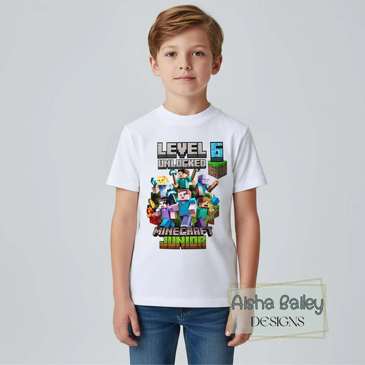 Minecraft Birthday T-Shirt, Boy wearing personalised Minecraft Level 6 Unlocked birthday t-shirt, white tee with colourful gamer design, front clearly visible, lifestyle setting