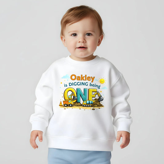 Digger birthdaysweatshirt personalised with child’s name and age, featuring colourful construction vehicles on a kids birthday jumper