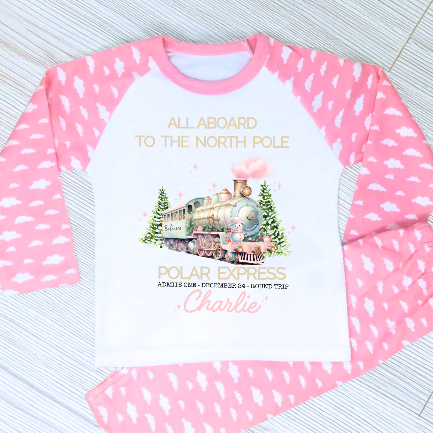 Polar express christmas pyjamas: A set of pink polar express Christmas Eve pyjamas for girls, personalised with a name. These pyjamas are designed to evoke the magic and wonder of the holiday season, made from soft, breathable fabric for a cozy night's sleep. Perfect for dreaming of a Polar Express journey to the North Pole. Girls polar express christmas pjs, christmas pyjamas personalised