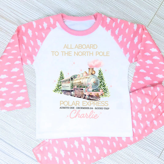 Polar express christmas pyjamas: A set of pink polar express Christmas Eve pyjamas for girls, personalised with a name. These pyjamas are designed to evoke the magic and wonder of the holiday season, made from soft, breathable fabric for a cozy night's sleep. Perfect for dreaming of a Polar Express journey to the North Pole. Girls polar express christmas pjs, christmas pyjamas personalised