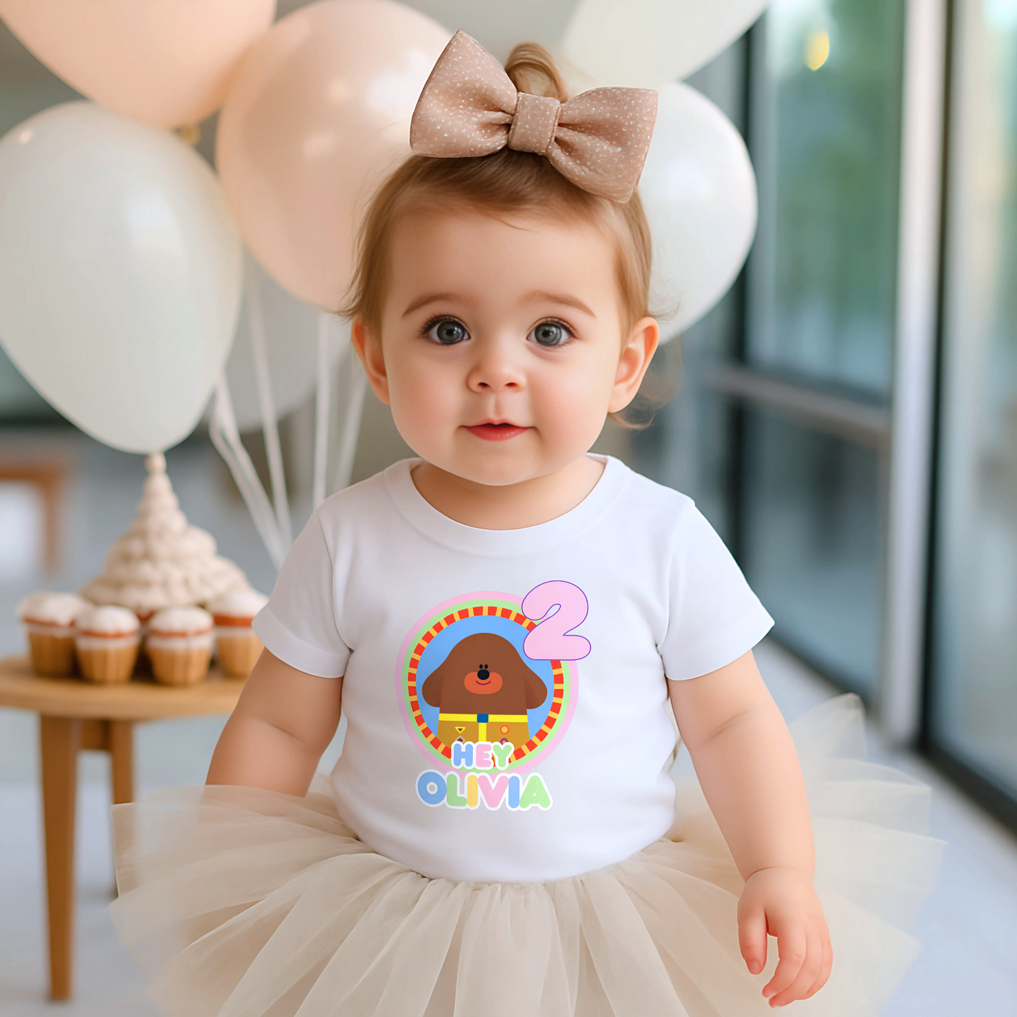 Hey Duggee Badge Birthday T-shirt: A lively and vibrant birthday t-shirt featuring the beloved character Hey Duggee, perfect for a child's special day. The shirt is customisable with the child's name and age, making it a personal keepsake. Made from 100% cotton, it promises comfort and durability for active play. The design's bright colours and the iconic Hey Duggee badge add a delightful touch that reflects the child's unique personality and love for the popular children's series.