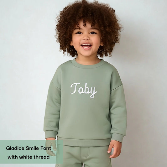 Personalised Embroidered Loungewear: A child wearing a two piece loungwear set with their name displayed on the front. Perfect for birthday and
