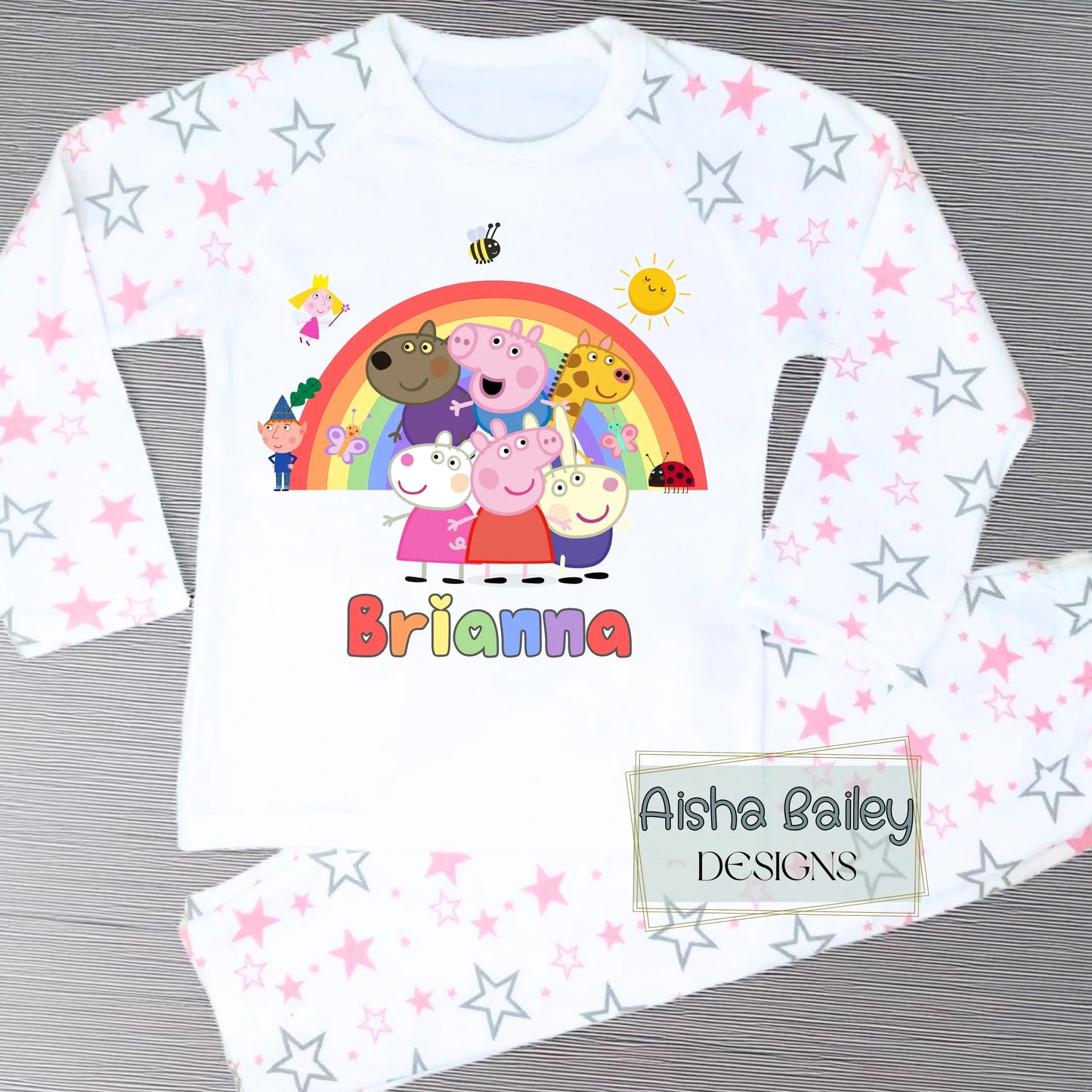 Pink Peppa Pig personalised girls pyjamas set featuring a colourful rainbow design and favourite Peppa Pig characters, customised with name and age. Made from soft, comfortable fabric with a long-sleeve top and matching cloud-print bottoms. Perfect for everyday wear, cosy nights, and relaxed mornings—ideal personalised Peppa Pig sleepwear for toddlers and young children.