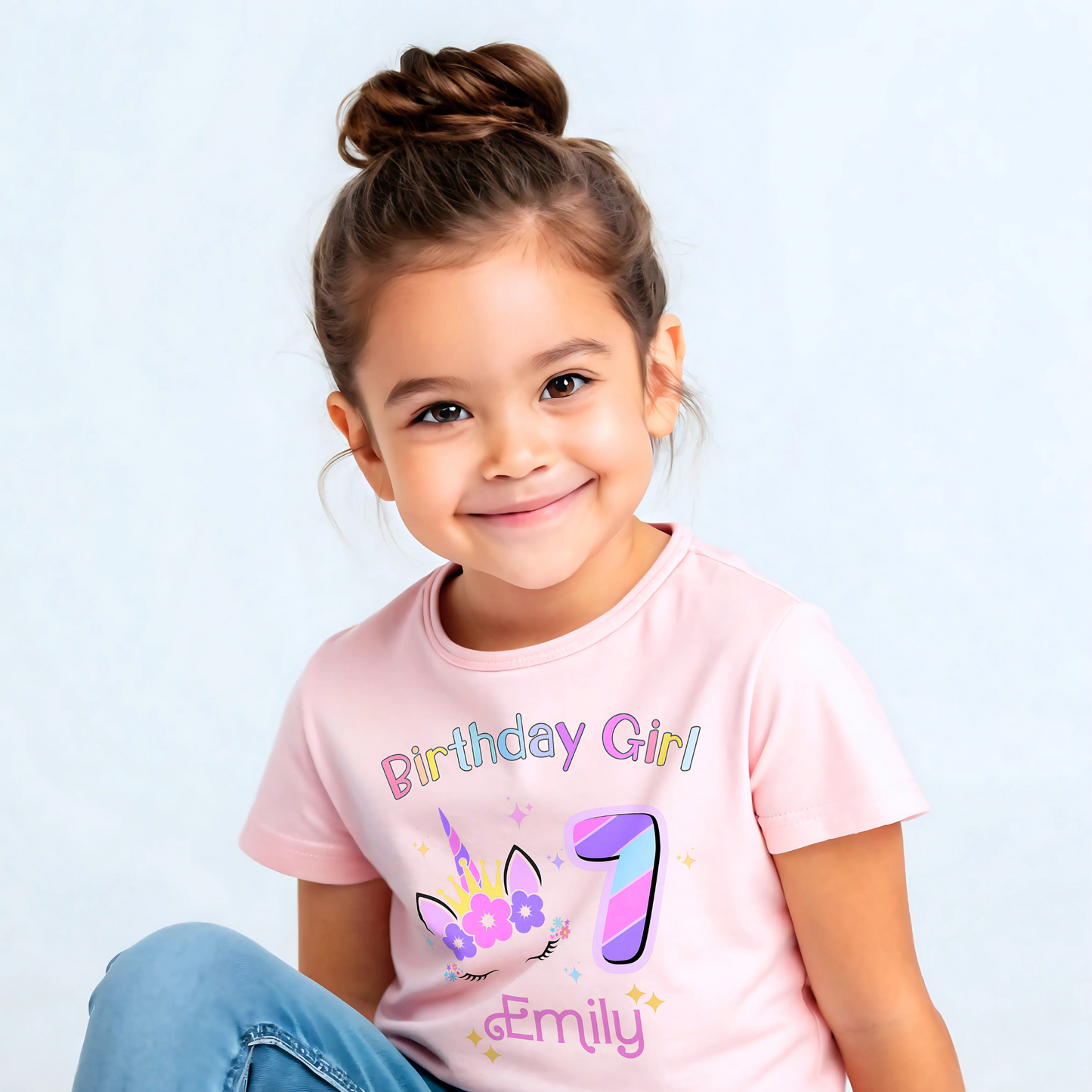 Unicorn Birthday T-shirt for girls, A personalised birthday t-shirt for girls, featuring a pink and purple unicorn design. The t-shirt is customisable with the child's name and age, making it a perfect birthday gift. The vibrant colours and whimsical unicorn imagery make it an ideal choice for a toddler celebrating her special day. The t-shirt is available in white, blue and pink.
