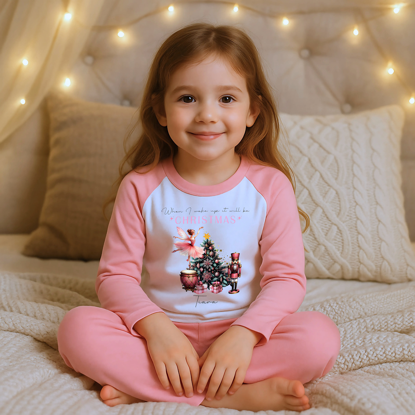 Girls personalised Christmas pyjamas featuring a beautifully illustrated ballerina as a Christmas fairy in dusky pink hues with nutcracker motifs in gold. These enchanting pyjamas offer a personalisation option to add a name, making them unique and ideal for gifting. Perfect for the Christmas season, they bring joy and become a treasured keepsake. Personalised Nutcracker Christmas Pyjamas, when i wake up it will be christmas