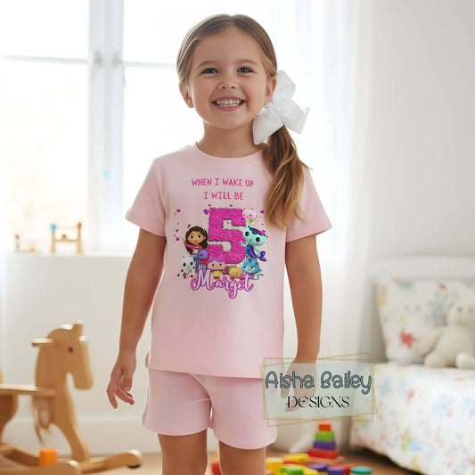 Personalised Gabby's Dollhouse birthday pyjamas for girls. Add name & age for a cute, comfy birthday sleepwear set. Perfect gift idea.
