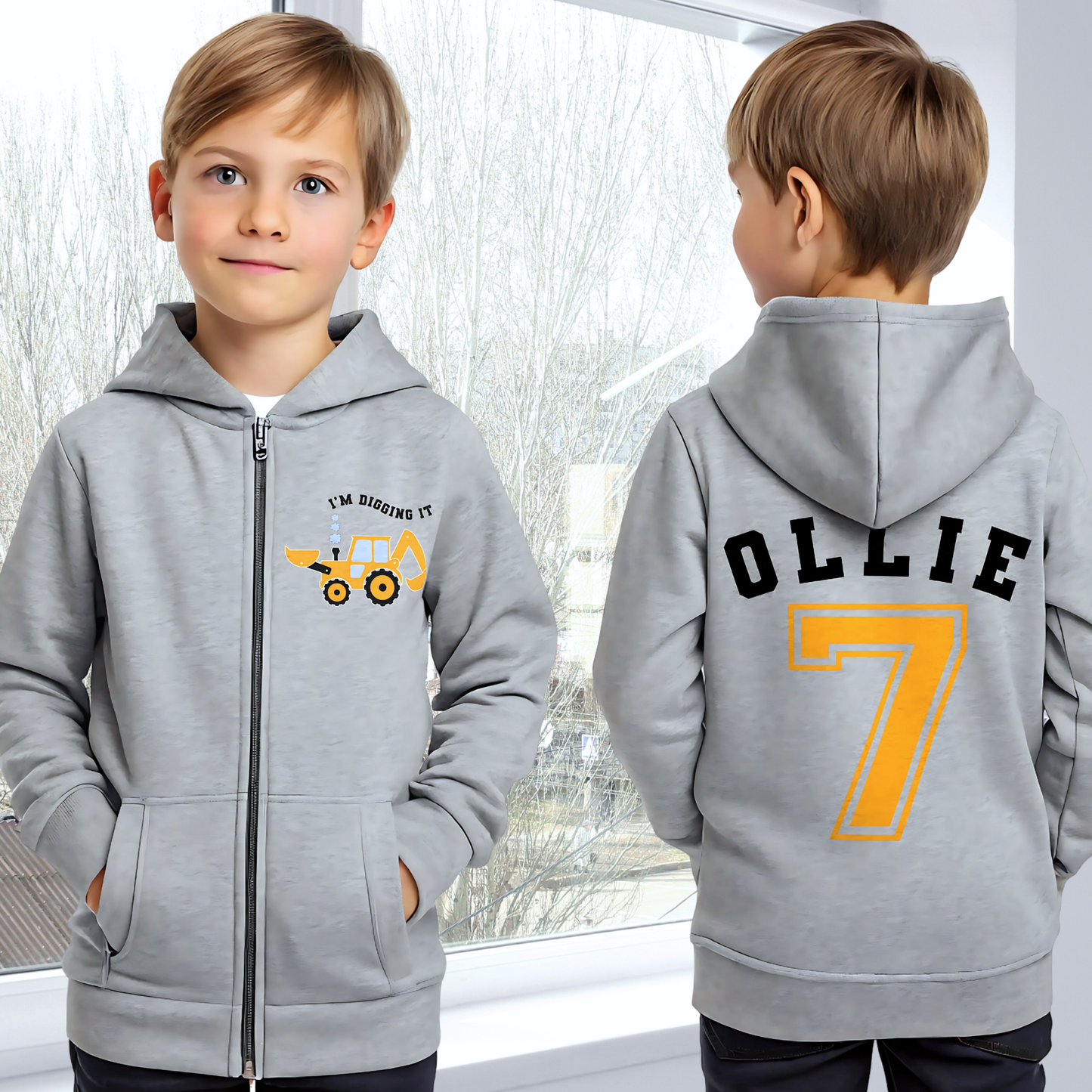 Boys Digger Hoodie: kids personalised zip-up hoodie featuring a playful construction theme. The back of the hoodie showcases the childs name and number in a varsity font. On the front is a vibrant print of a digger or tractor with the words I am Digging it, adding a fun touch for young construction enthusiasts. Great for toddler birthday gifts, graphic hoodie for boys, birthday gift, Name and Number Hoodie for Kids.
