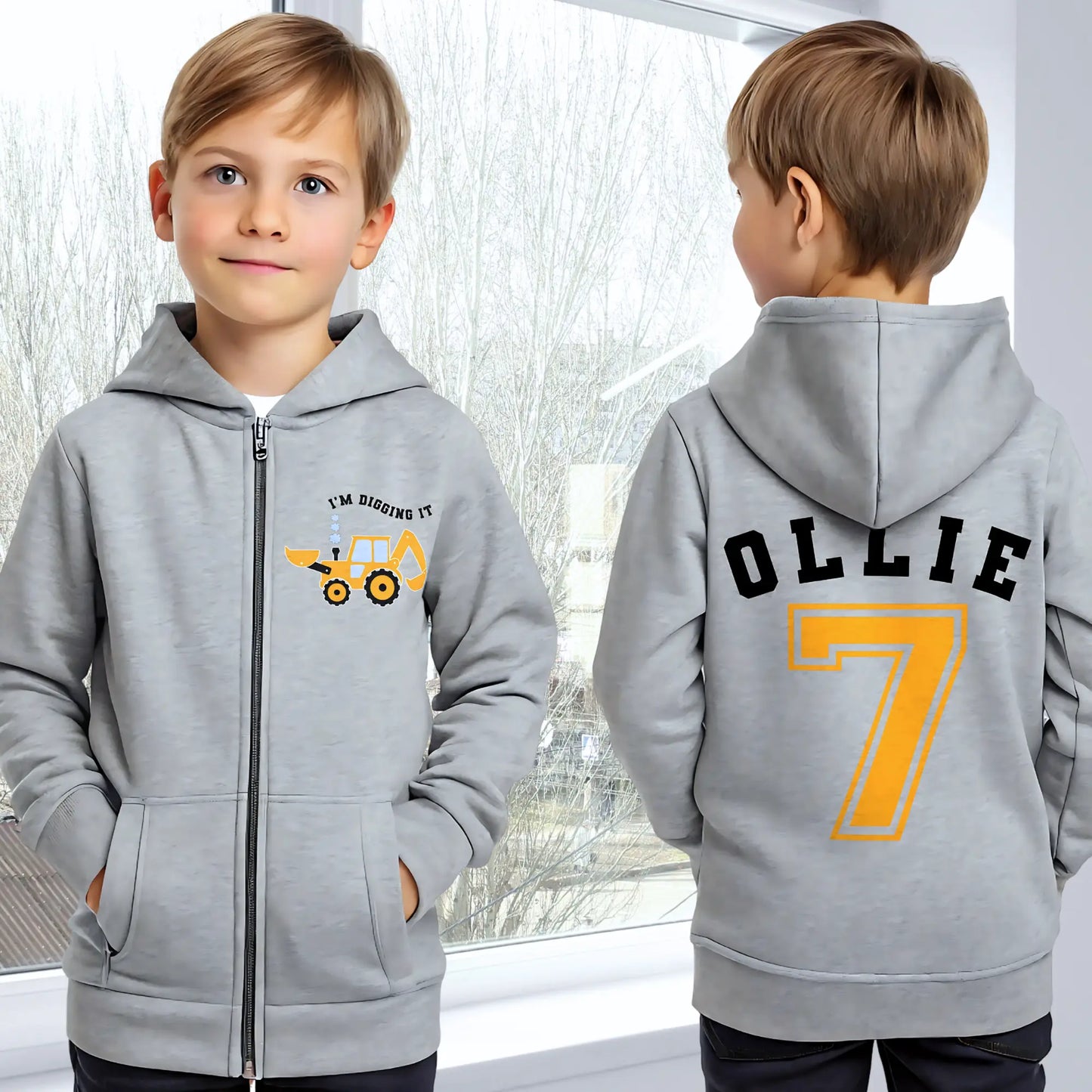 Boys Digger Hoodie: kids personalised zip-up hoodie featuring a playful construction theme. The back of the hoodie showcases the childs name and number in a varsity font. On the front is a vibrant print of a digger or tractor with the words I am Digging it, adding a fun touch for young construction enthusiasts. Great for toddler birthday gifts, graphic hoodie for boys, birthday gift, Name and Number Hoodie for Kids.