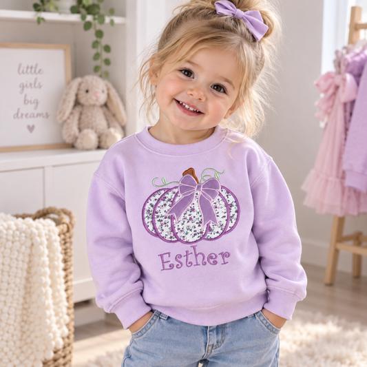 Personalised Halloween Sweatshirt for girls with embroidered floral pumpkin, purple bow and custom name, available in pink, lilac and white