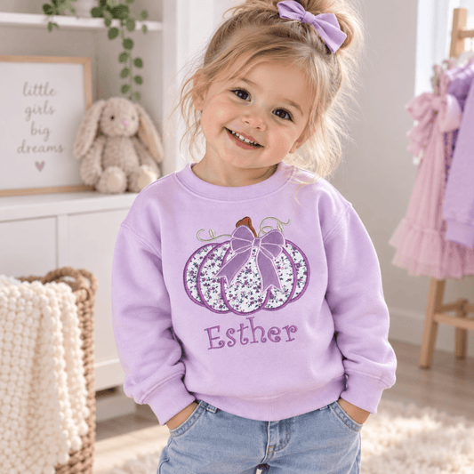 Personalised Halloween Sweatshirt for girls with embroidered floral pumpkin, purple bow and custom name, available in pink, lilac and white