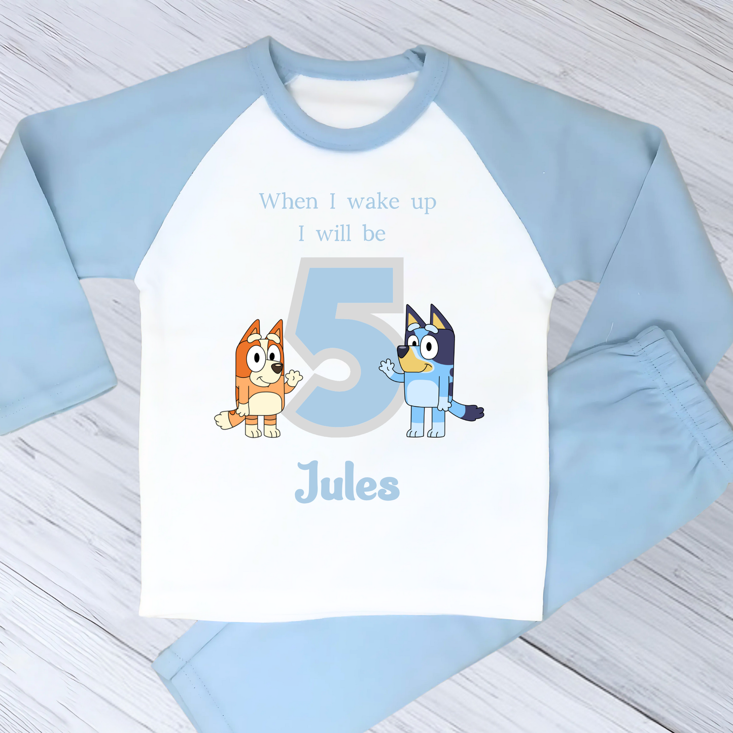 Personalised Bluey and Bingo birthday pujamas featuring vibrant prints of the beloved characters and a number to indicate the child's age. These delightful pyjamas, complete with the child's name, make bedtime an exciting continuation of the birthday festivities. Perfect for creating cherished birthday traditions and adding joy to the special day. Bluey pyjamas, Bingo pyjamas, birthday pyjamas, personalised children's pyjamas, birthday celebration, bedtime fun, toddler birthday