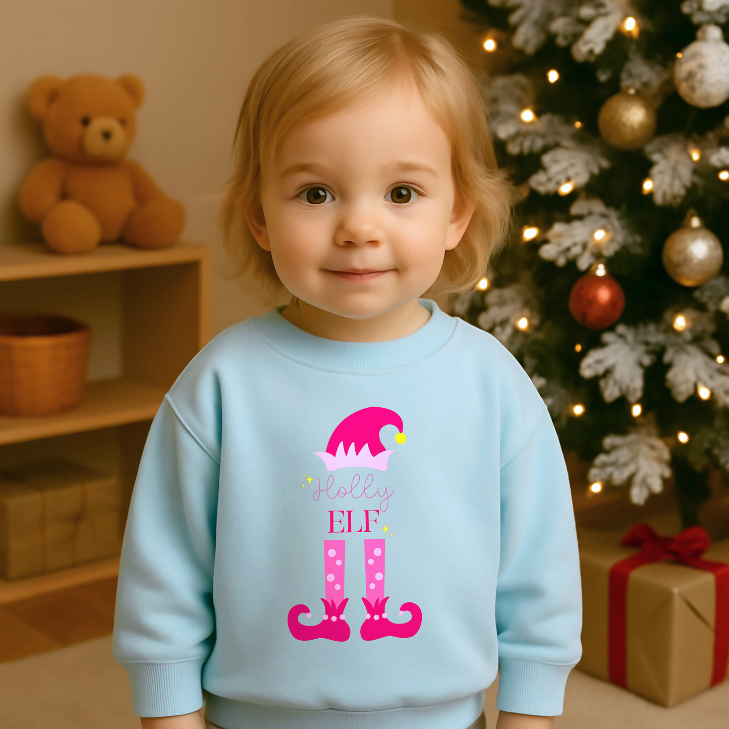 Personalised christmas elf sweatshirt: A pink sweatshirt featuring a cute elf design. It’s personalised with a child's name, adding a special touch to the festive season. Made from soft, high-quality materials for comfort and warmth. Ideal for Christmas gatherings and events, particularly Christmas jumper day