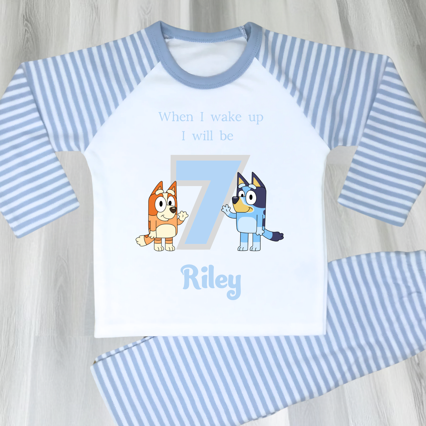Personalised Bluey and Bingo birthday pujamas featuring vibrant prints of the beloved characters and a number to indicate the child's age. These delightful pyjamas, complete with the child's name, make bedtime an exciting continuation of the birthday festivities. Perfect for creating cherished birthday traditions and adding joy to the special day. Bluey pyjamas, Bingo pyjamas, birthday pyjamas, personalised children's pyjamas, birthday celebration, bedtime fun, toddler birthday