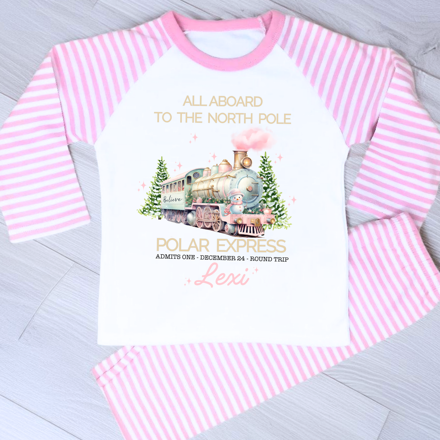 Polar express christmas pyjamas: A set of pink polar express Christmas Eve pyjamas for girls, personalised with a name. These pyjamas are designed to evoke the magic and wonder of the holiday season, made from soft, breathable fabric for a cozy night's sleep. Perfect for dreaming of a Polar Express journey to the North Pole. Girls polar express christmas pjs, christmas pyjamas personalised