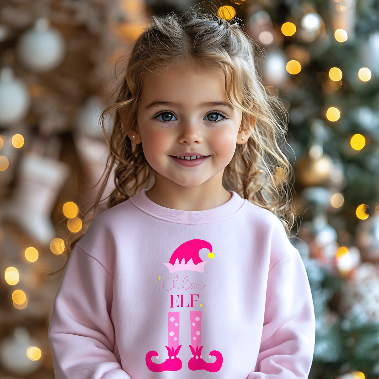 Personalised christmas elf sweatshirt: A pink sweatshirt featuring a cute elf design. It’s personalised with a child's name, adding a special touch to the festive season. Made from soft, high-quality materials for comfort and warmth. Ideal for Christmas gatherings and events, particularly Christmas jumper day