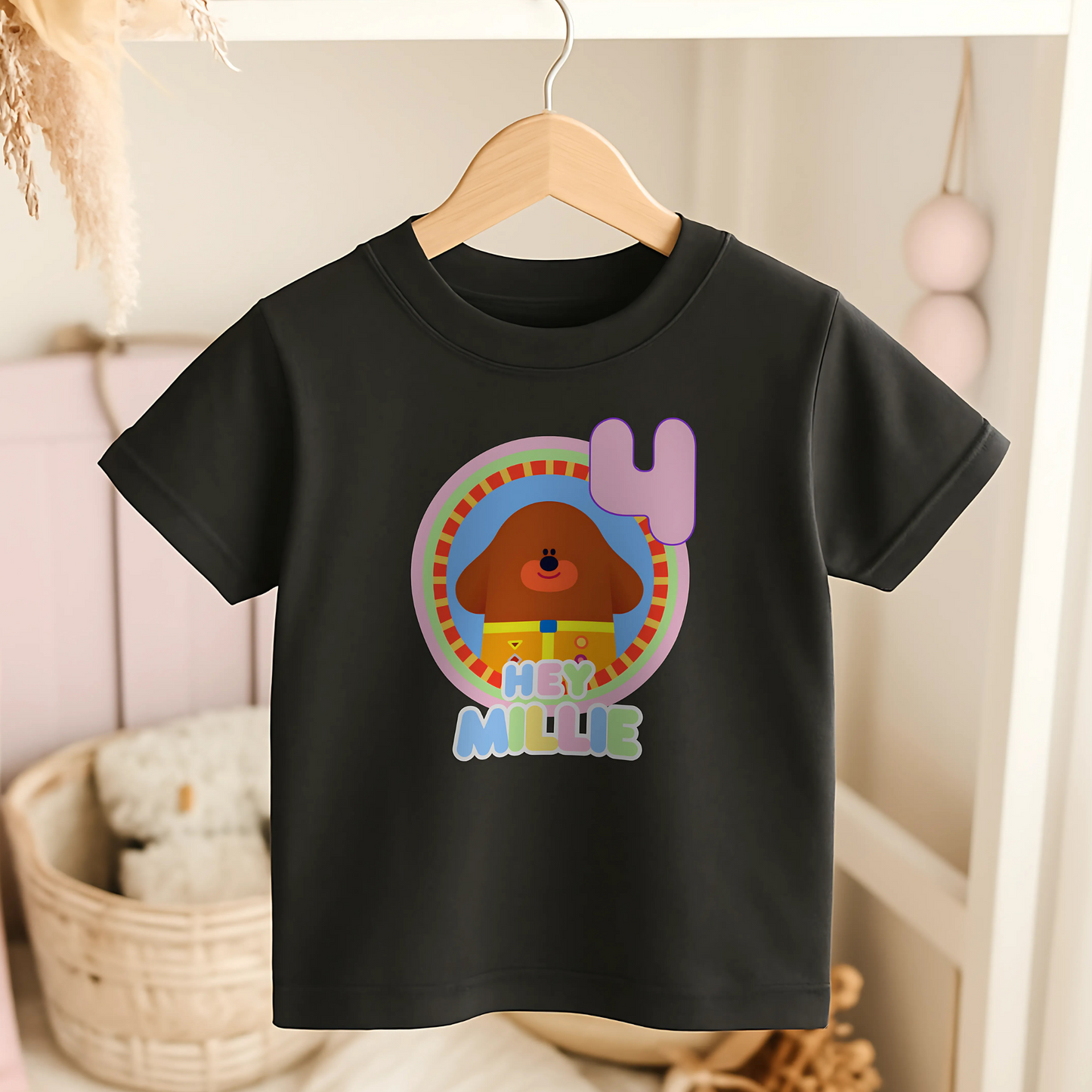 Hey Duggee Badge Birthday T-shirt: A lively and vibrant birthday t-shirt featuring the beloved character Hey Duggee, perfect for a child's special day. The shirt is customisable with the child's name and age, making it a personal keepsake. Made from 100% cotton, it promises comfort and durability for active play. The design's bright colours and the iconic Hey Duggee badge add a delightful touch that reflects the child's unique personality and love for the popular children's series.