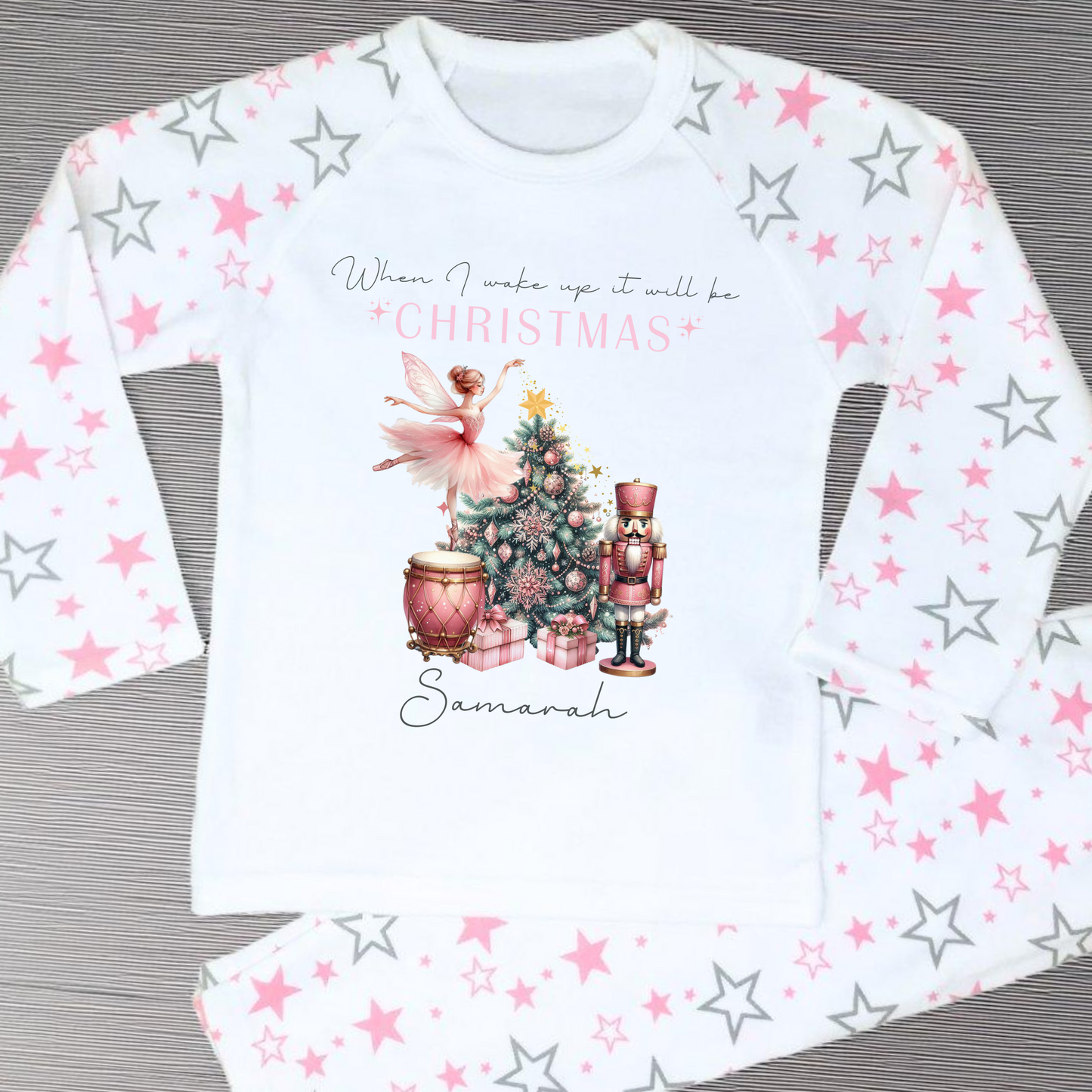 Girls personalised Christmas pyjamas featuring a beautifully illustrated ballerina as a Christmas fairy in dusky pink hues with nutcracker motifs in gold. These enchanting pyjamas offer a personalisation option to add a name, making them unique and ideal for gifting. Perfect for the Christmas season, they bring joy and become a treasured keepsake. Personalised Nutcracker Christmas Pyjamas, when i wake up it will be christmas