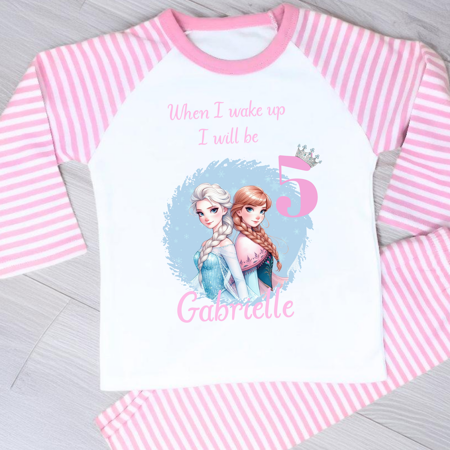Personalised Frozen birthday pyjamas with name and age. Features Elsa and Anna in Frozen colours of blue and lilac. Perfect for birthday morning photos and celebrations.