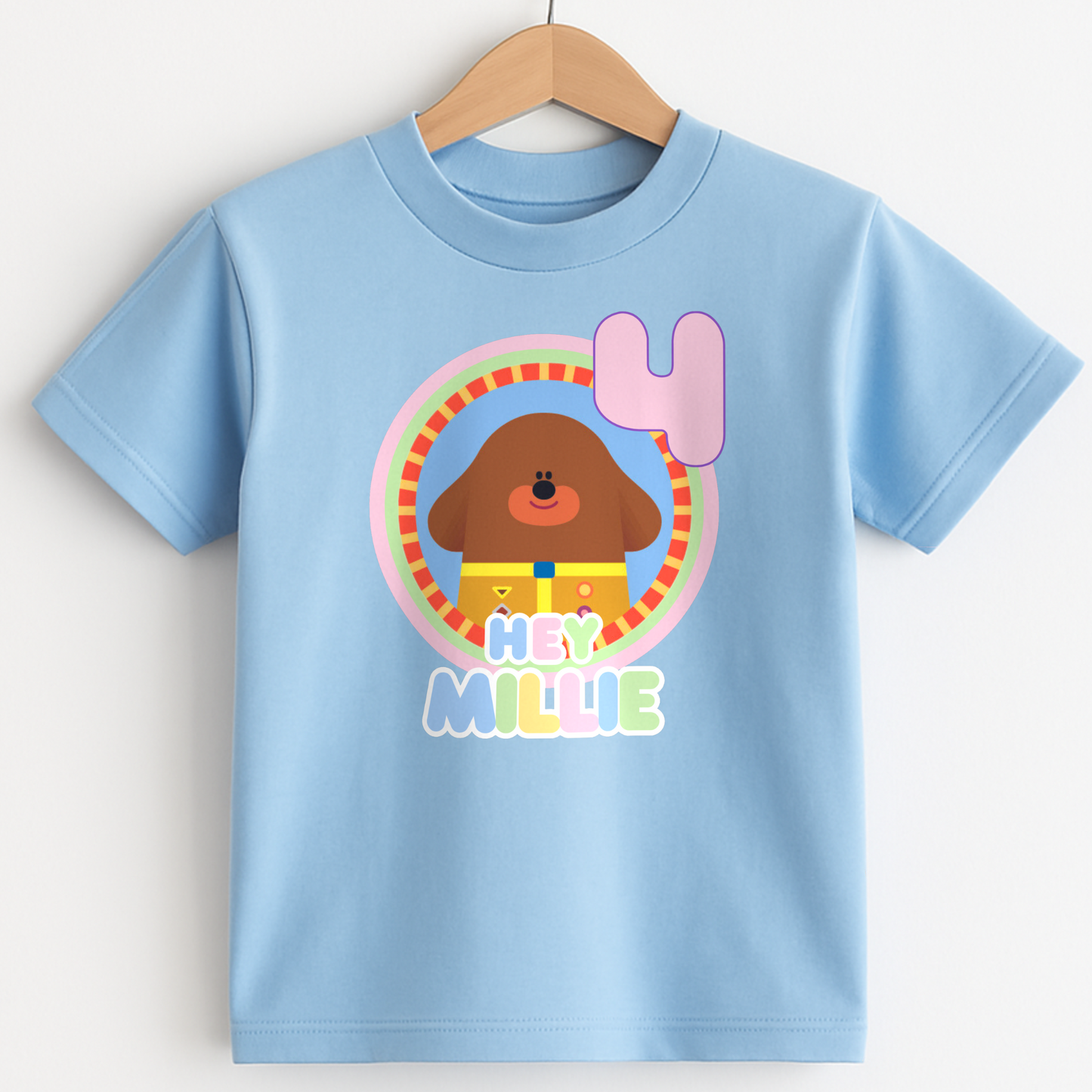 Hey Duggee Badge Birthday T-shirt: A lively and vibrant birthday t-shirt featuring the beloved character Hey Duggee, perfect for a child's special day. The shirt is customisable with the child's name and age, making it a personal keepsake. Made from 100% cotton, it promises comfort and durability for active play. The design's bright colours and the iconic Hey Duggee badge add a delightful touch that reflects the child's unique personality and love for the popular children's series.