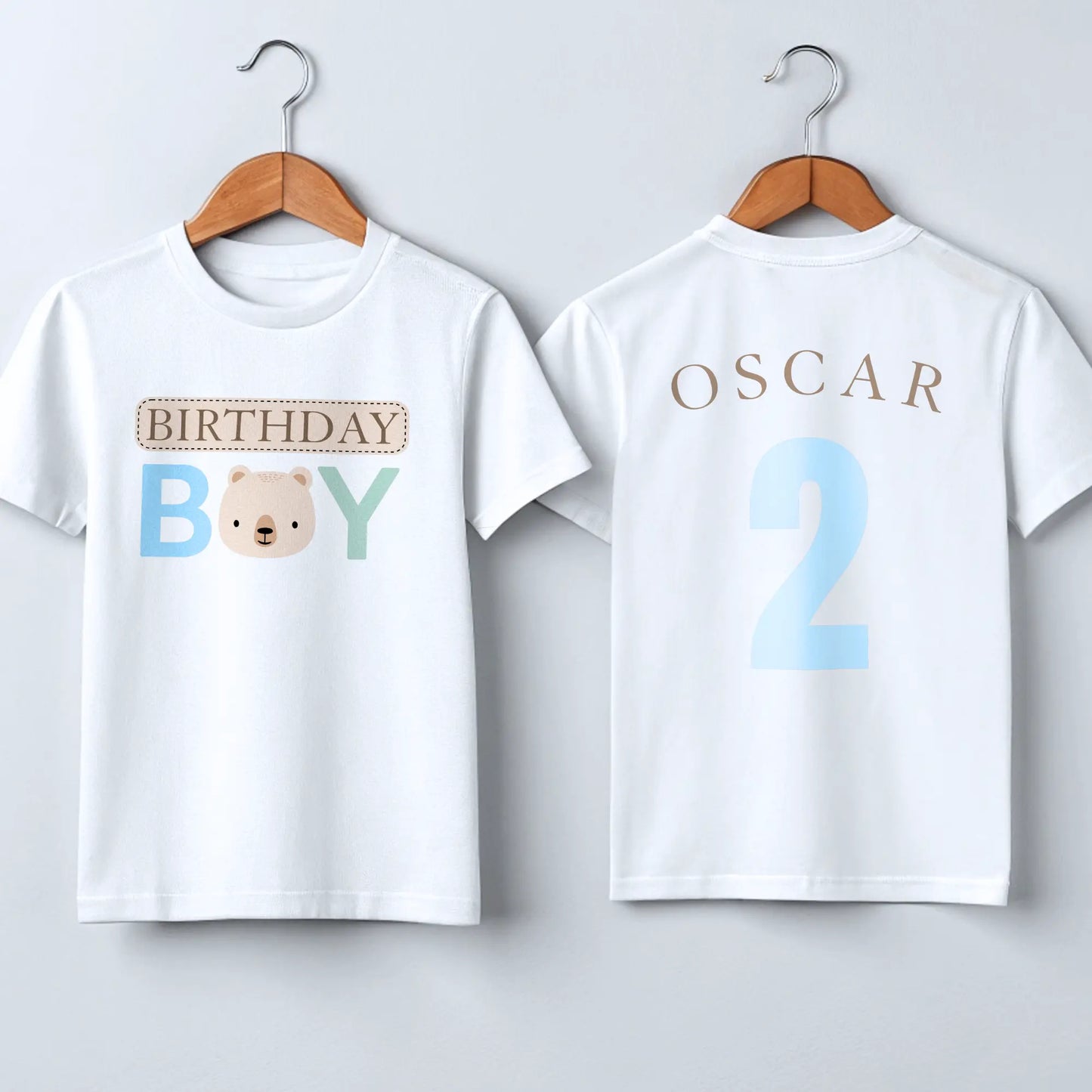 Teddy Bear Birthday T-shirt, Personalized Brown Bear Birthday T-Shirt: A charming white t-shirt showcasing a neutral theme with an adorable teddy bear head graphic and the words “Birthday Boy” in eye-catching beige, blue, and sage tones. The back is personalized with the child's name and age, making it the perfect birthday gift or celebration outfit for a toddler boy, ideal for memorable birthday photos and parties.