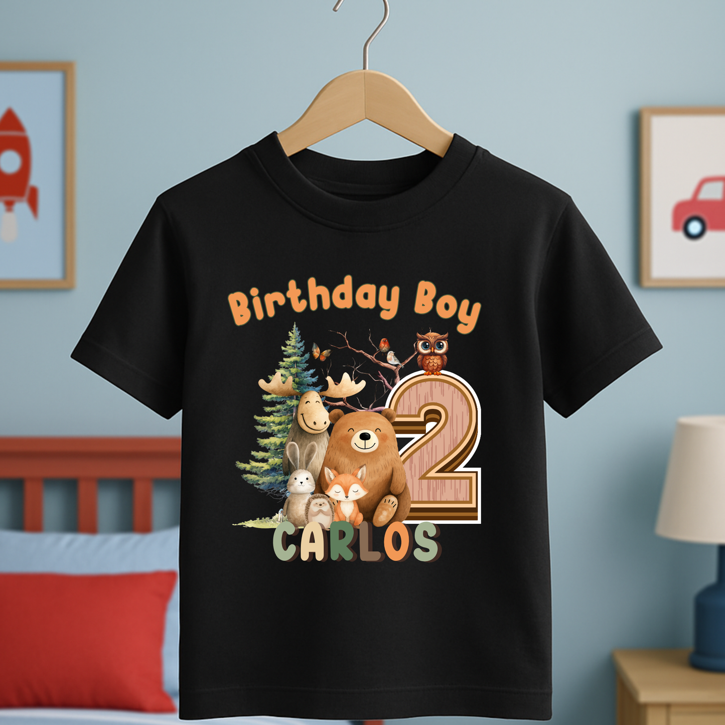 Woodland animal birthday t-shirt: A children's birthday t-shirt featuring a woodland animal theme. The shirt displays a forest scene with a playful fox, a curious bear, and a gentle bear, surrounded by lush greenery. The design uses earthy tones and vibrant greens to create a natural look. At the top, the words “Birthday Boy” are printed, with space for a personalized name underneath. Made from soft, high-quality fabric, it’s designed for comfort and durability.