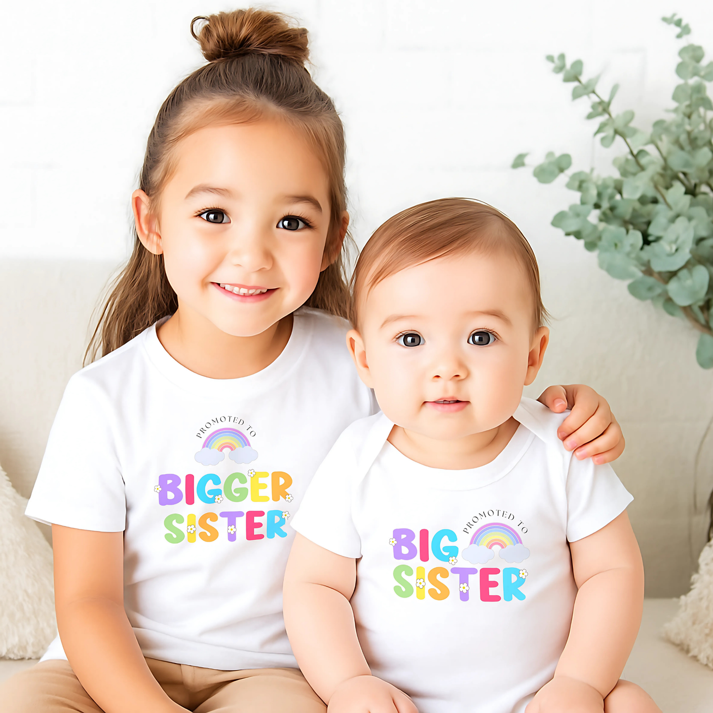 promoted to big sister t-shirt: A girls personalised promoted to big sister pregnancy announcement t-shirt featuring the phrase "I am going to be a Big Sister" in vibrant rainbow colours. This is designed to celebrate a big or bigger sister role. Customisable with a special date, it serves as a keepsake for capturing precious sibling moments and marking the start of a new journey. Perfect for sharing the exciting news with family and the world. Matching Sibling, Big Sister Shirt