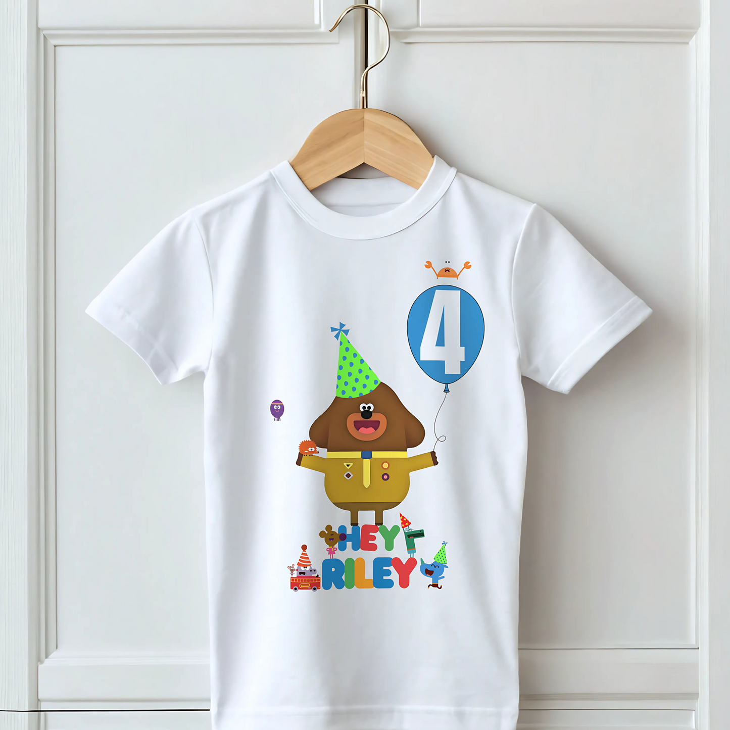 hey duggee birthday t-shirt: A vibrant and colourful Hey Duggee birthday t-shirt for boys, featuring Hey Duggee and the Squirrels. The toddler birthday shirt is personalised with the child's name and age, displayed within a cheerful blue balloon. Toddler birthday t-shirt, gift ideas for toddlers, personalised hey duggee shirt
