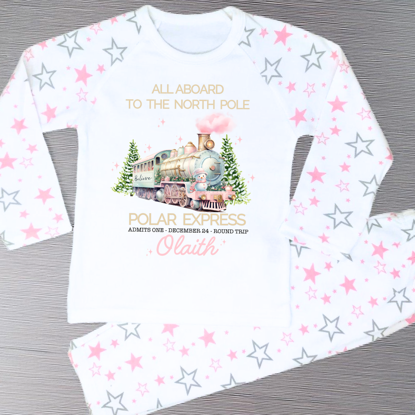 Polar express christmas pyjamas: A set of pink polar express Christmas Eve pyjamas for girls, personalised with a name. These pyjamas are designed to evoke the magic and wonder of the holiday season, made from soft, breathable fabric for a cozy night's sleep. Perfect for dreaming of a Polar Express journey to the North Pole. Girls polar express christmas pjs, christmas pyjamas personalised