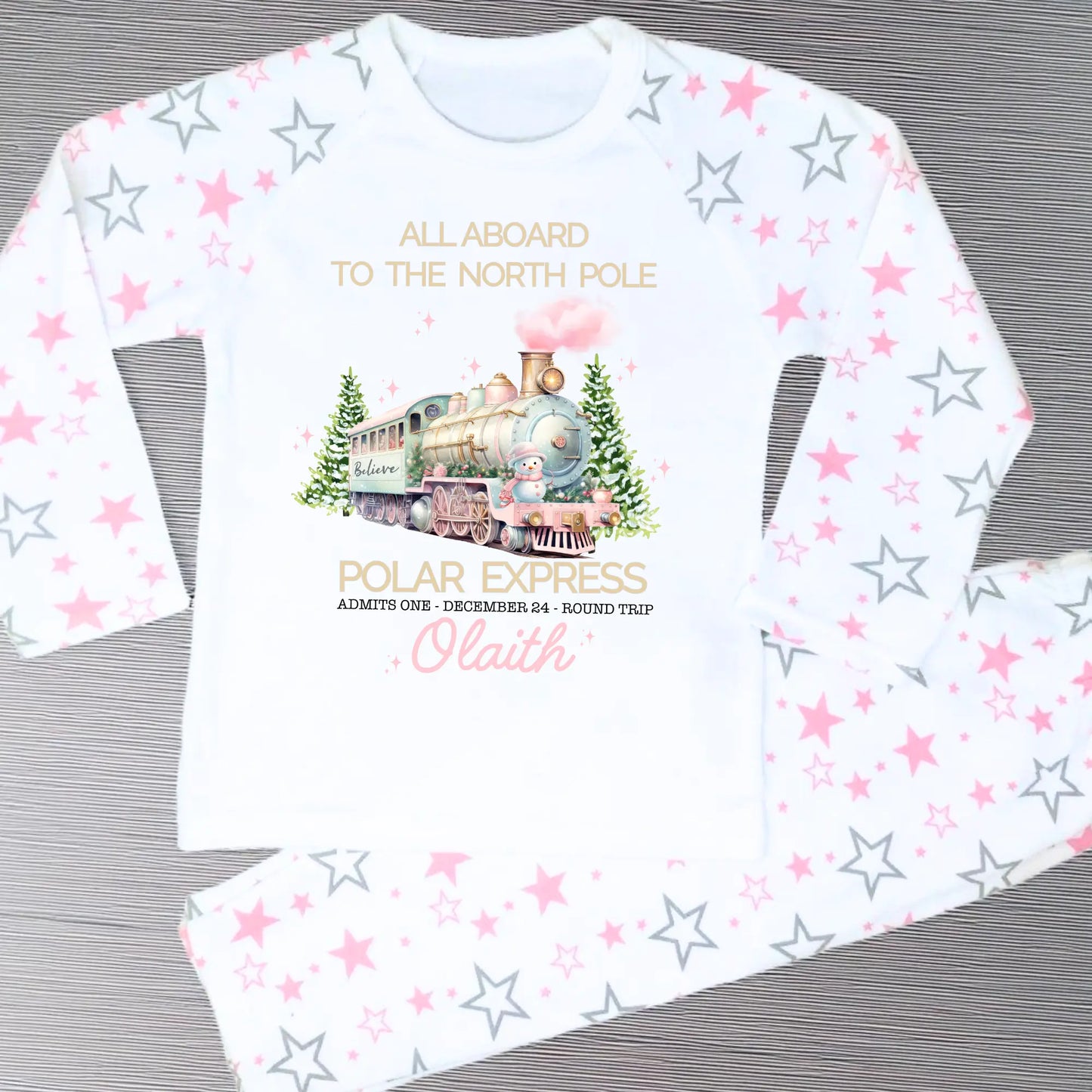 Polar express christmas pyjamas: A set of pink polar express Christmas Eve pyjamas for girls, personalised with a name. These pyjamas are designed to evoke the magic and wonder of the holiday season, made from soft, breathable fabric for a cozy night's sleep. Perfect for dreaming of a Polar Express journey to the North Pole. Girls polar express christmas pjs, christmas pyjamas personalised