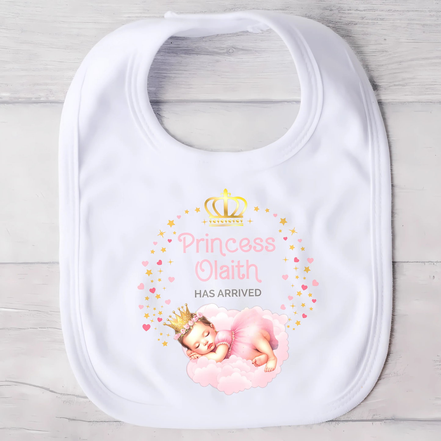 Personalised baby outfit: A collection of vibrant and charming baby clothes, featuring sleepsuits, bodysuits, T-shirts, and bibs, all designed for baby girls. The items are part of the “Personalised Baby Girls The Princess Has Arrived” collection.. The collection allows for customisation with a baby’s name, making these pieces ideal for gifts or special occasions. This will make a great newborn baby gift for gender reveal, baby shower, or to welcome a new baby coming home outfit.