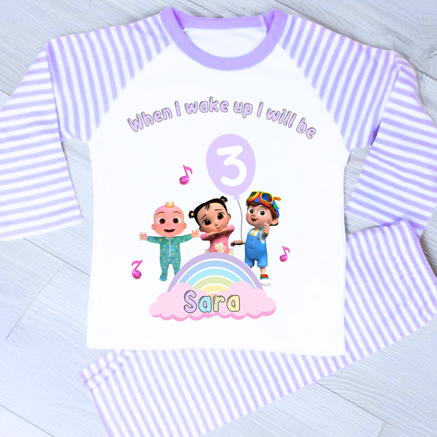Cocomelon Birthday Pyjamas: Image of a set of Cocomelon Birthday Pyjamas for children, displayed on a soft, pastel-hued background. The pyjamas are made from a soft fabric and showcase a pastel rainbow color scheme, adorned with popular Cocomelon characters. The ensemble is designed to be both stylish and comfortable, making it perfect for birthday celebrations or a cosy night. The image emphasizes the playful and whimsical nature of the pyjamas, capturing the essence of fun for young fans of Cocomelon.