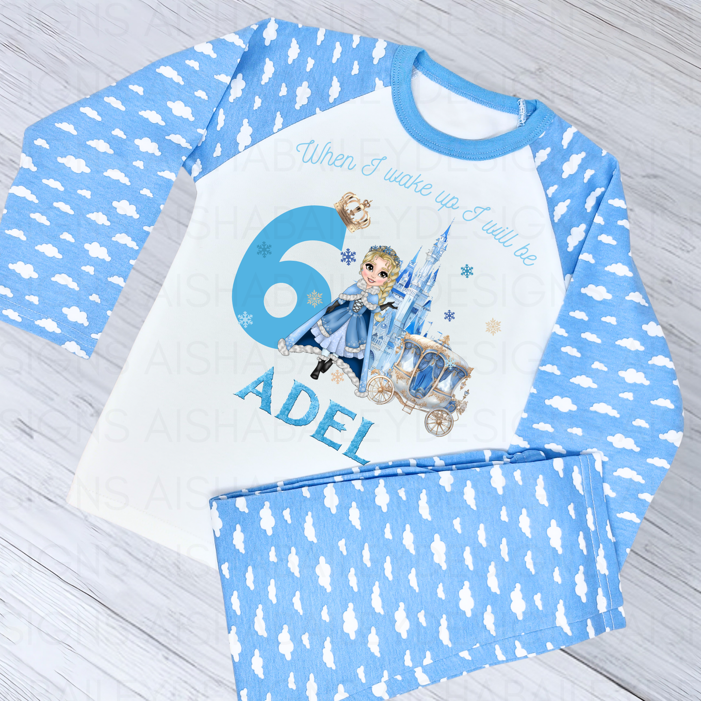 Princess birthday pyjamas: A set of personalised girls princess birthday pyjamas, titled "When I Wake Up Blue Snow Princess Custom Dolly Set." The pyjamas, made from 100% cotton for comfort, feature a customisable princess dolly with unique features and can be personalised with a child's name. Perfect for making a birthday girl feel like royalty with their enchanting design, ideal for birthday parties, sleepovers, or lounging at home.