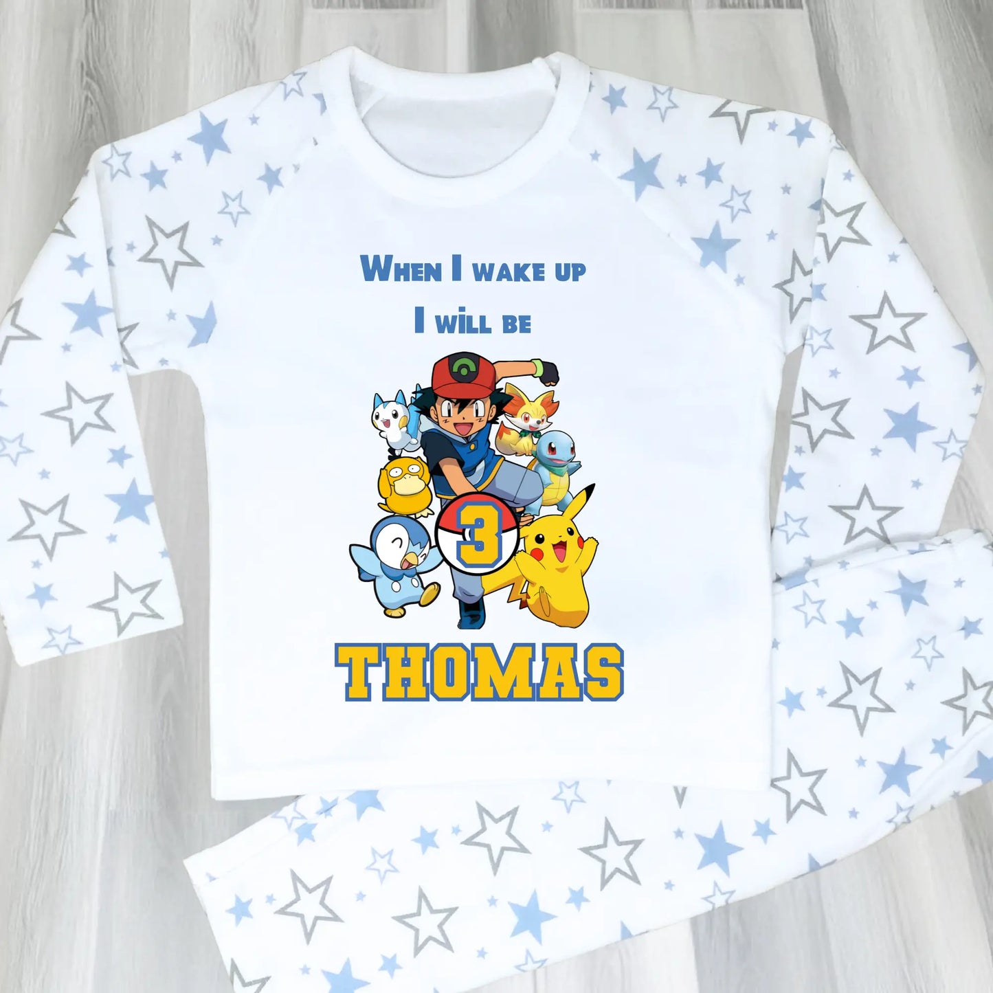 Pokomon birthday pyjamas: Children's PJst with Pokomon characters and text on a light blue and white background