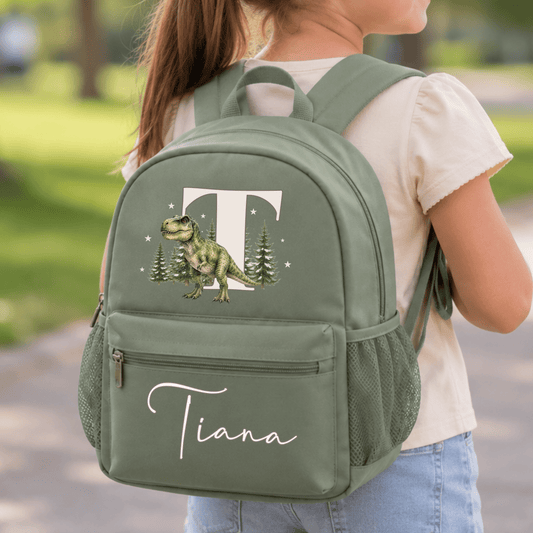 Personalised dinosaur backpack for boys with realistic watercolour T-Rex, woodland initial and custom name on sage, beige and blue school rucksack.
