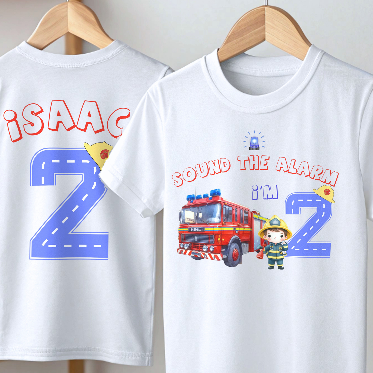 Personalised Fire Engine Birthday T-Shirt: A customizable white birthday shirt featuring a red fire truck and firefighter. The top reads “Sound the Alarm I'm” followed by your choice of age number. The back displays the toddler's name and a blue number adorned with a firefighter hat. An ideal gift for firefighter-themed birthday parties for toddlers.