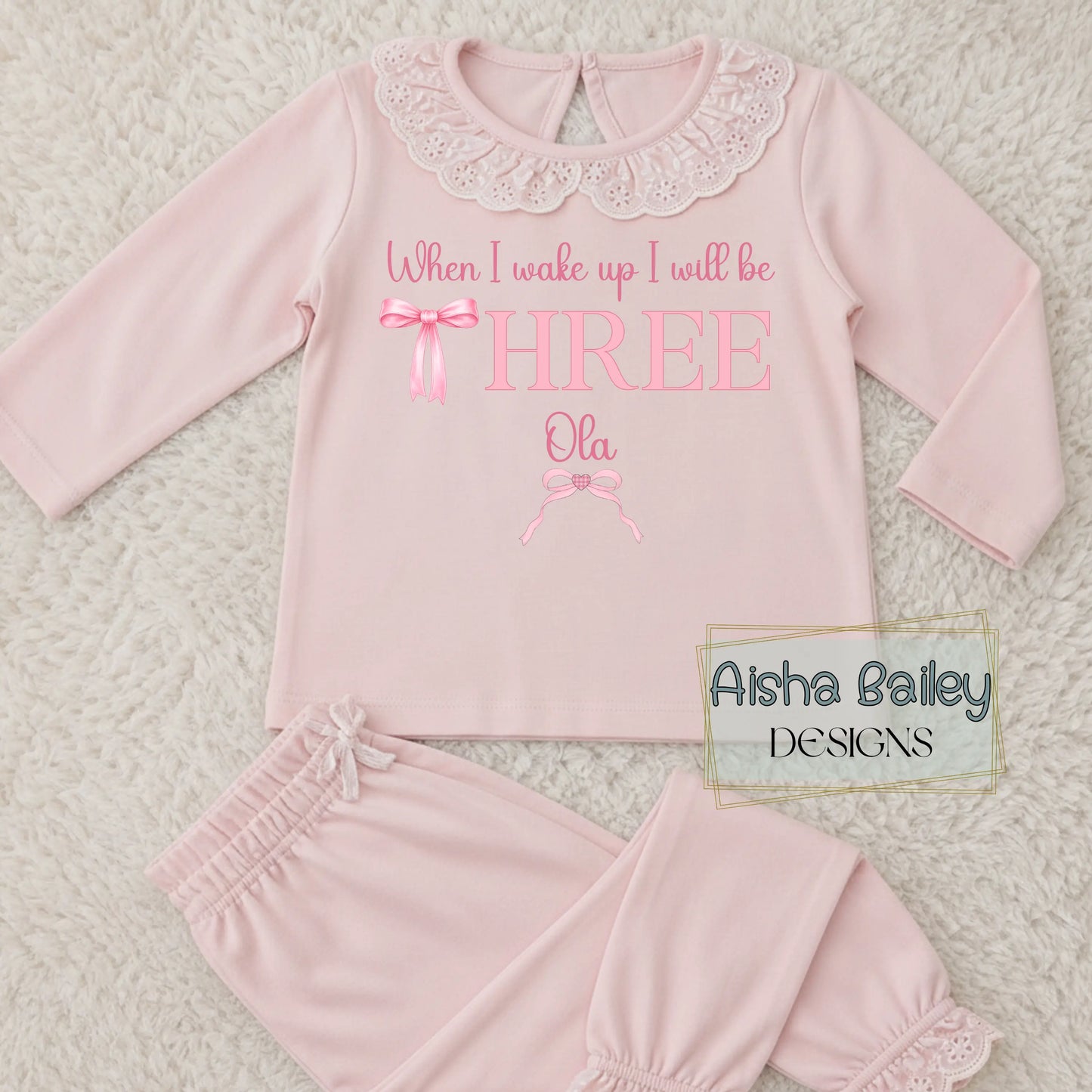pink girls birthday pyjamas with pink bow and frilly collar