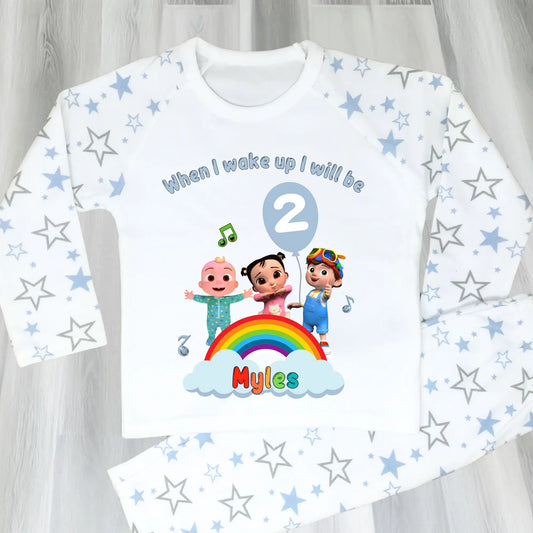 Cocomelon Birthday Pyjamas: Image of a set of Cocomelon Birthday Pyjamas for children, displayed on a soft, pastel-hued background. The pyjamas are made from a soft fabric and showcase a pastel rainbow color scheme, adorned with popular Cocomelon characters. The ensemble is designed to be both stylish and comfortable, making it perfect for birthday celebrations or a cosy night. The image emphasizes the playful and whimsical nature of the pyjamas, capturing the essence of fun for young fans of Cocomelon.