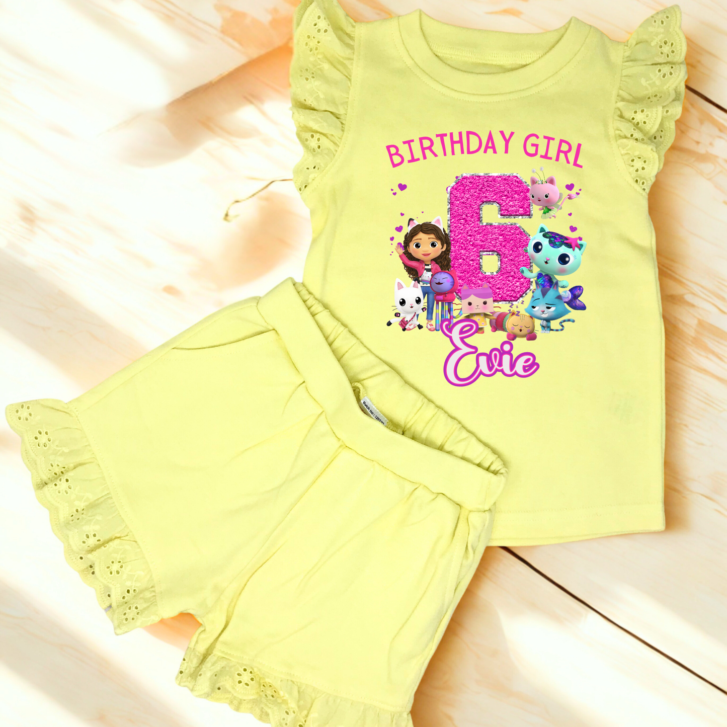 Gabby's dollhouse birthday outfit, An adorable personalised birthday outfit inspired by Gabbie's Dollhouse, featuring a frilly top and matching shorts. The ensemble can be customised with any name and age, making it perfect for a special birthday celebration. Perfect birthday gift for girls, personalised summer outfit