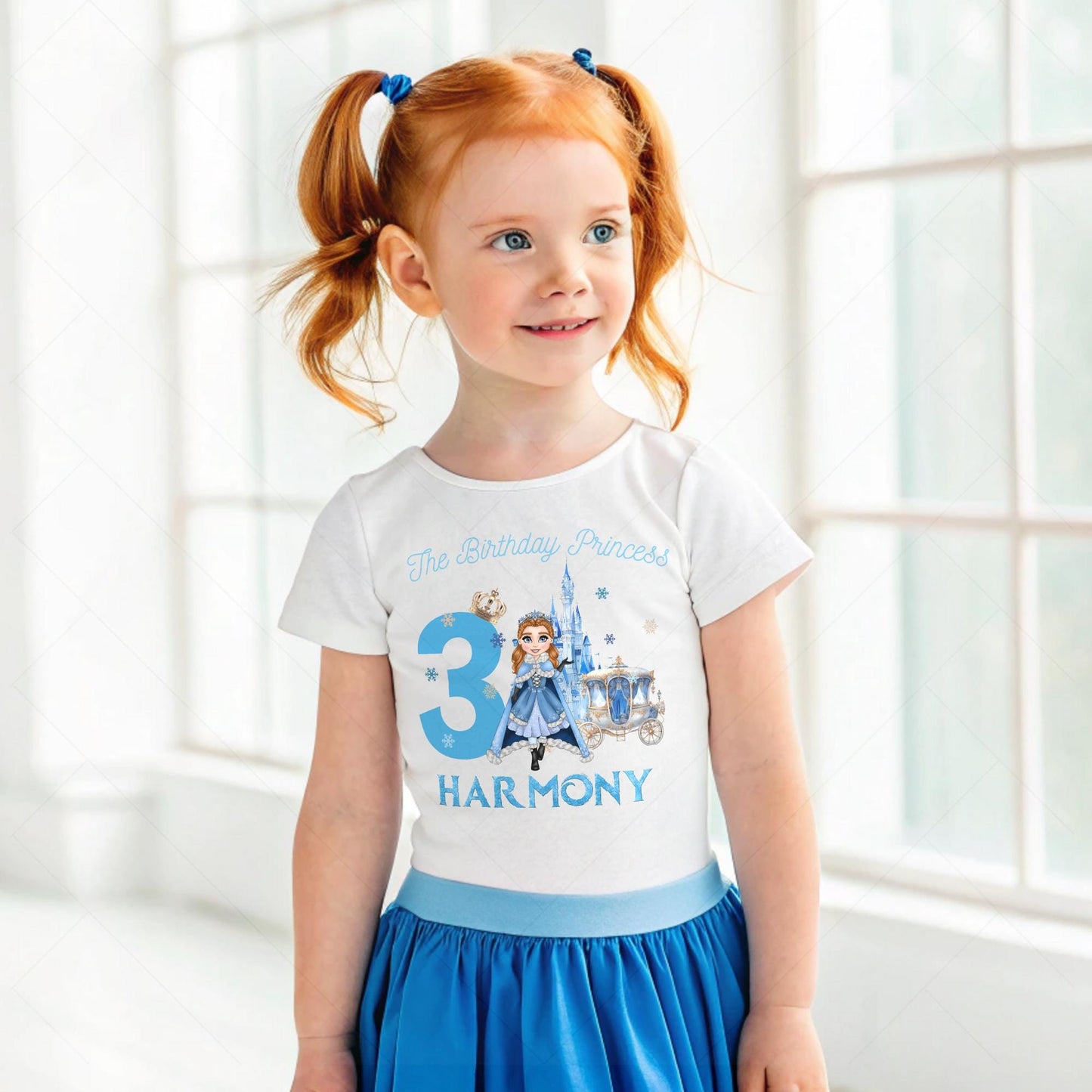 A charming, personalized girls' birthday T-shirt designed for a princess-themed celebration. The design is a soft blue, reminiscent of an ice princess's gown, crafted from 100% cotton for comfort. Its front features a delightful illustration of a snow princess, surrounded by delicate snowflakes. The design is completed with customizable elements, displaying a name and age in elegant, white script. This tee is perfect for creating a magical birthday experience for any young princess.