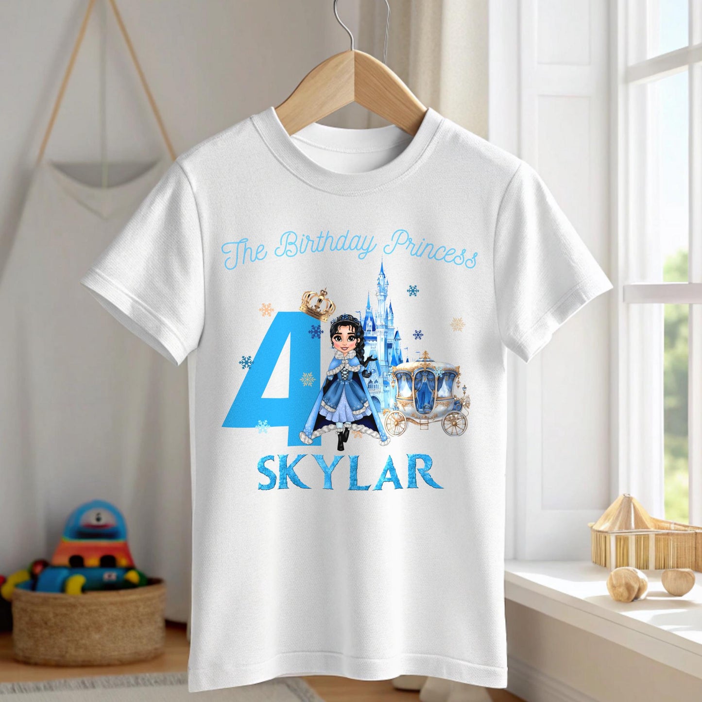 A charming, personalized girls' birthday T-shirt designed for a princess-themed celebration. The design is a soft blue, reminiscent of an ice princess's gown, crafted from 100% cotton for comfort. Its front features a delightful illustration of a snow princess, surrounded by delicate snowflakes. The design is completed with customizable elements, displaying a name and age in elegant, white script. This tee is perfect for creating a magical birthday experience for any young princess.