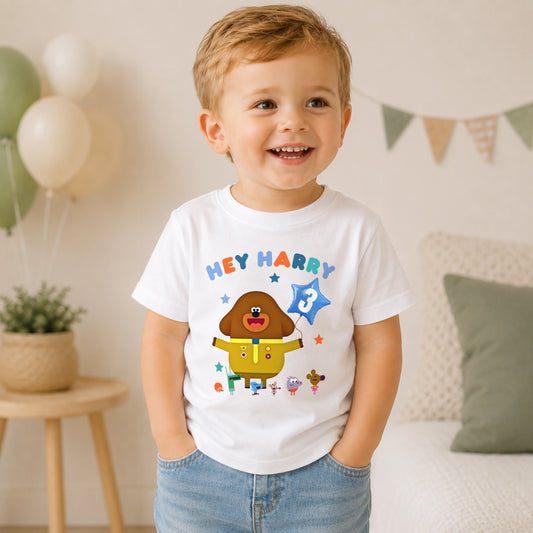 A personalised Hey Duggee kids birthday t-shirt featuring a colourful character design and the text "HEY Harry" on the front.