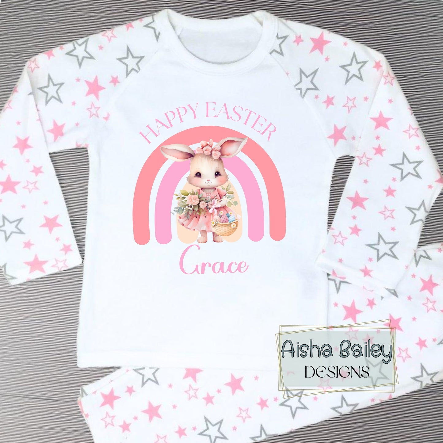 Personalised Easter Pyjamas for girls with their custom name. Bunny Rainbow design in soft pink pastel tones