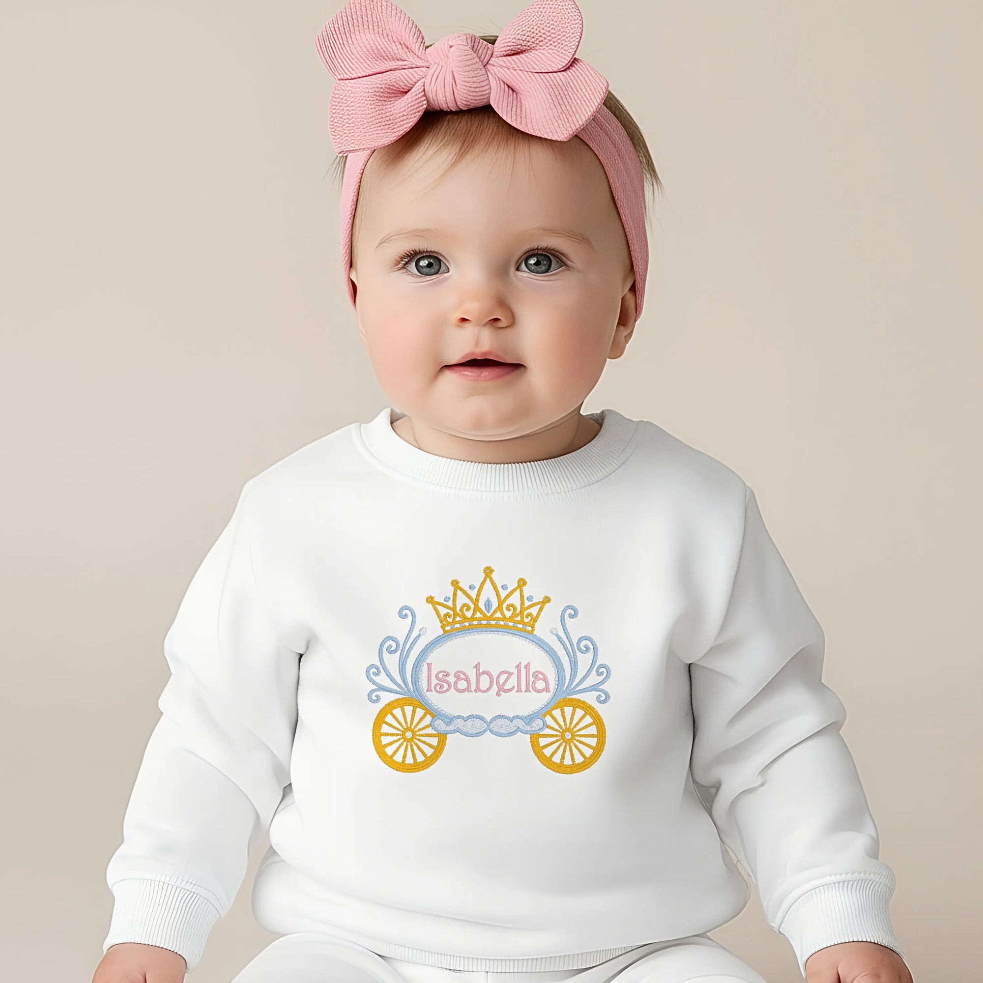 Child wearing personalised embroidered sweatshirt for gils with a princess carriage