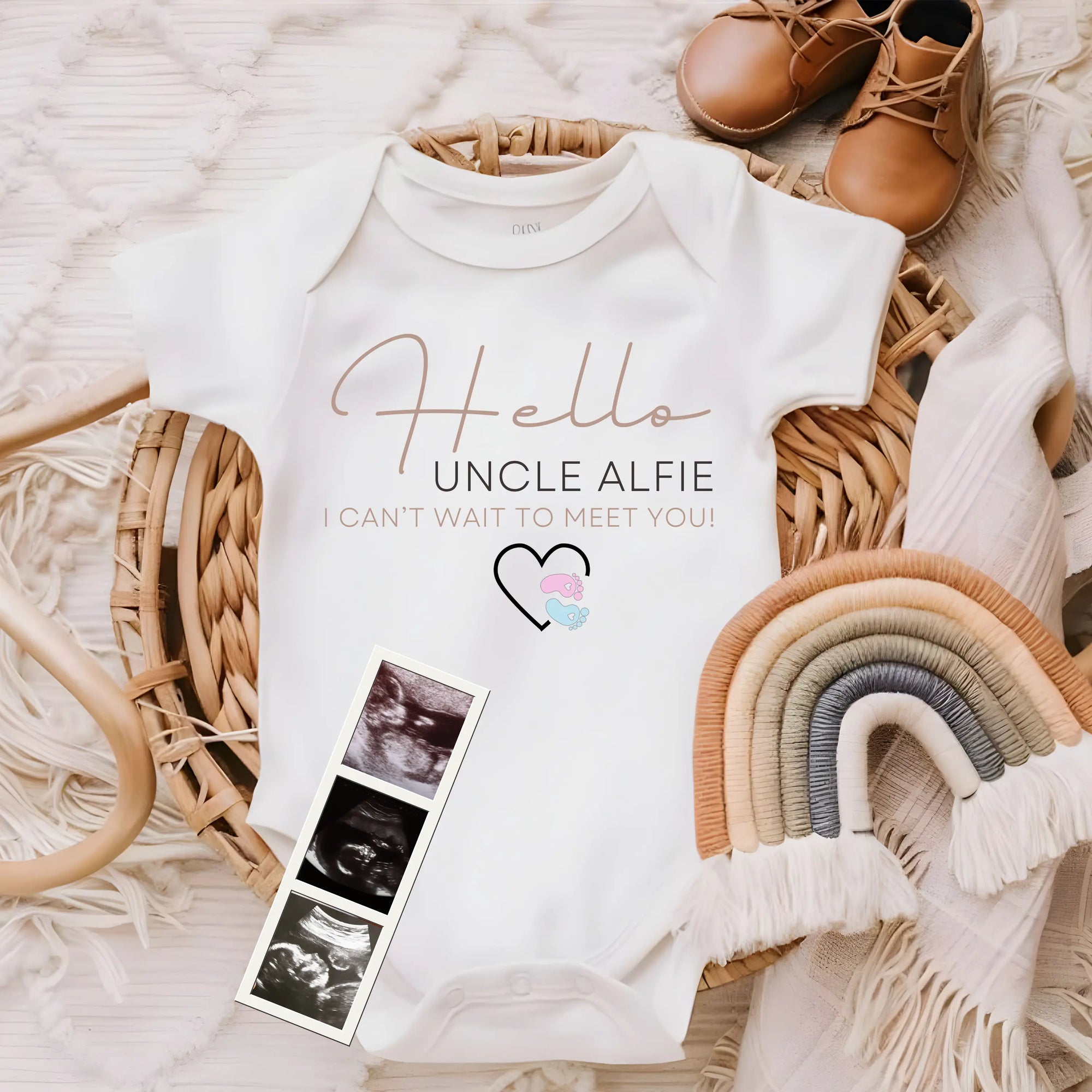 Personalised baby grow styled with baby shoes, keepsake accessories and ultrasound photos, representing personalised baby gifts and newborn clothing.