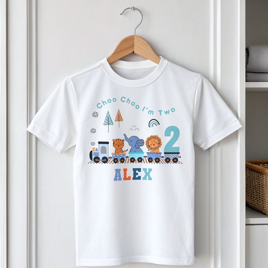 White cotton t-shirt featuring a vibrant safari jungle theme designed for a boy's birthday party. The top is personalised with the phrase ‘Choo Choo I'm Two,’ or any age, and adorned with playful illustrations of jungle animals like lions, elephants, and giraffes, perfect for a safari-themed celebration. Also for boys that love trains. Boys toddler birthday shirt, personalised toddler gift ideas, jungle animal themed birthday party ideas.